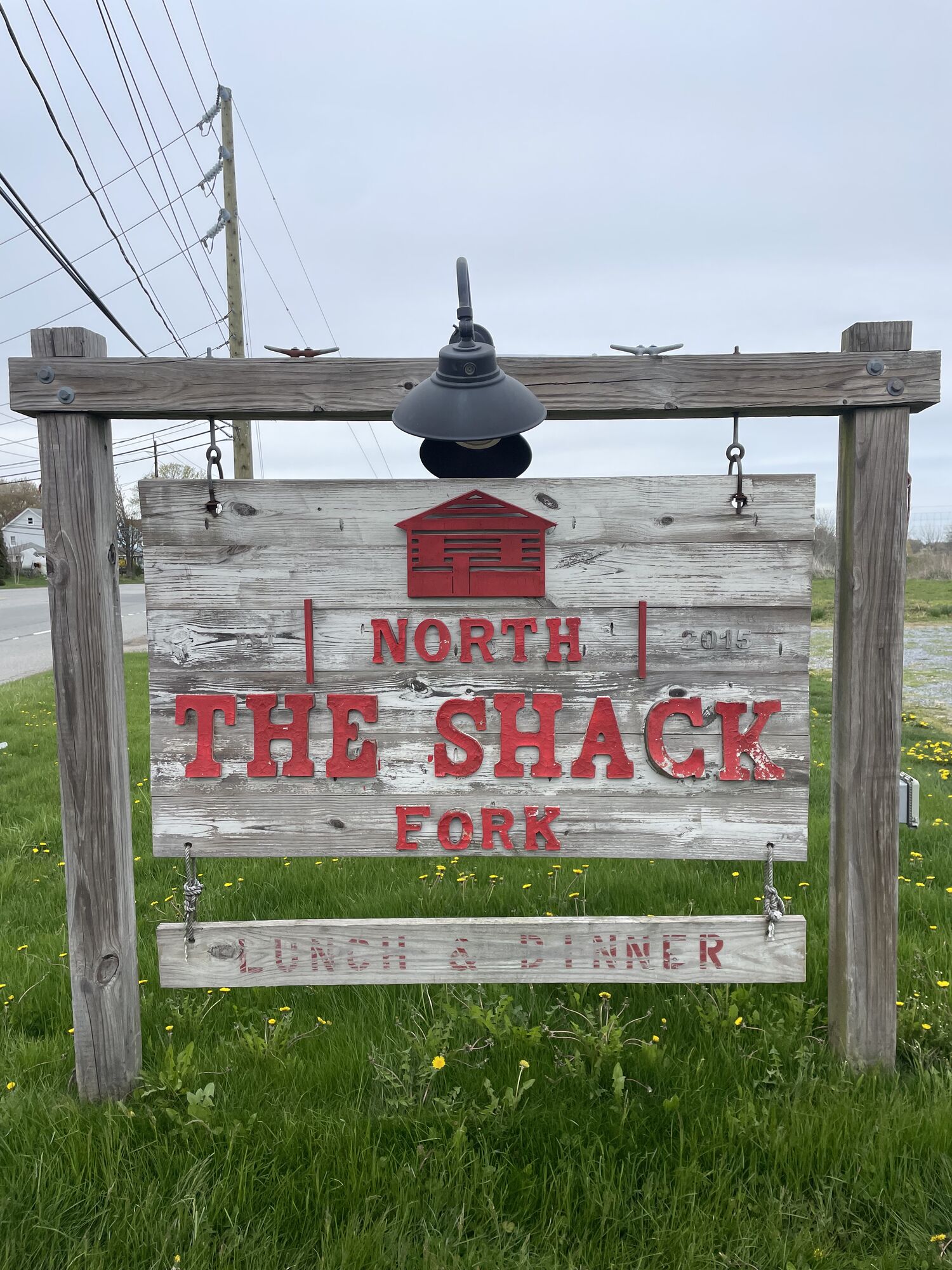Weathered wooden North Fork Shack roadside sign reading Lunch & Dinner